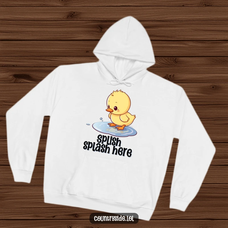 Funny Kawaii duckling character, looking delighted and slightly wet, humorously splashing in a puddle on a hoodie.